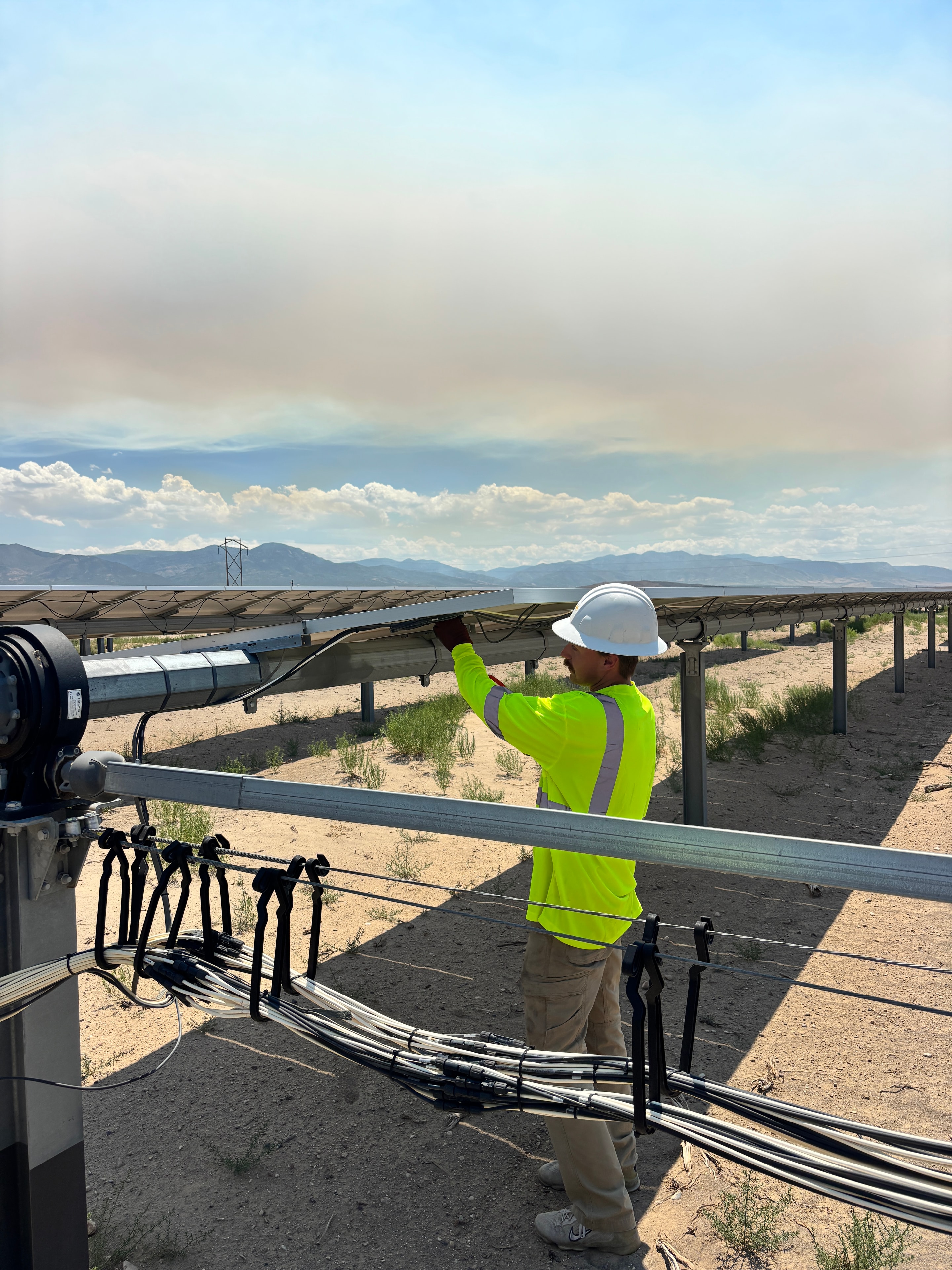 Solar technicians inspecting panels on-site